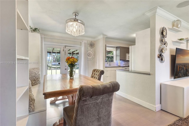 11450 NW 45th Pl, Sunrise, FL 33323 - dining space featuring baseboards, a notable chandelier, ornamental molding, and plenty of natural light
