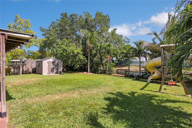 11450 NW 45th Pl, Sunrise, FL 33323 - view of yard featuring an outdoor structure, a fenced backyard, and a storage shed