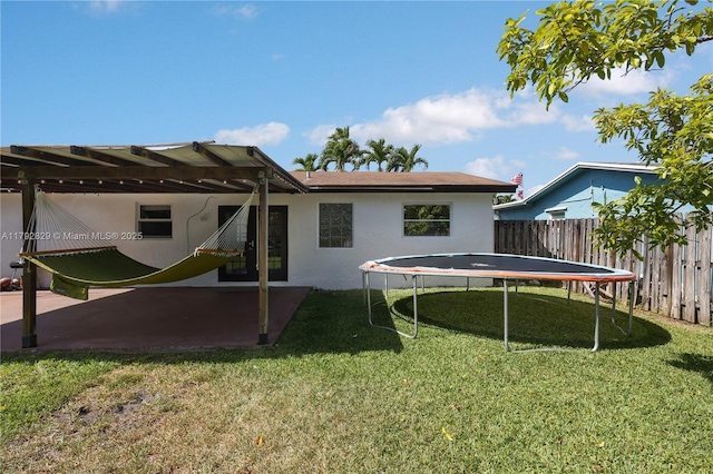11450 NW 45th Pl, Sunrise, FL 33323 - rear view of property featuring a yard, fence, and stucco siding