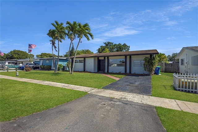 11450 NW 45th Pl, Sunrise, FL 33323 - ranch-style home featuring a front lawn, fence, and driveway