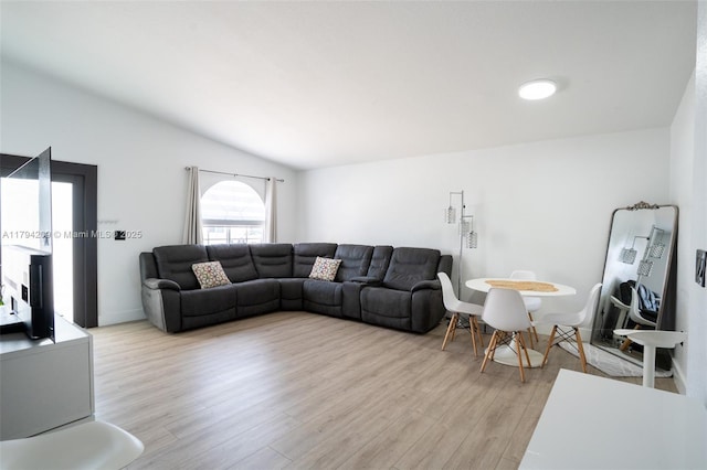 living room with vaulted ceiling and light wood finished floors