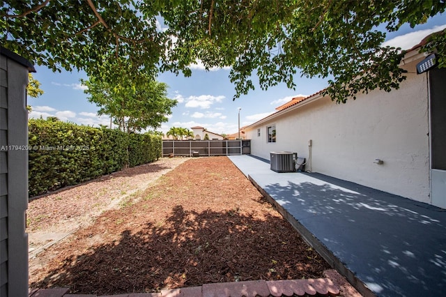 view of yard with central air condition unit, a patio, and a fenced backyard