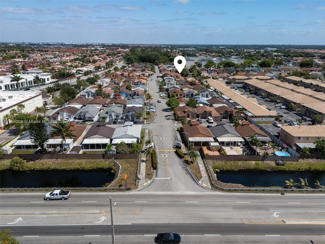drone / aerial view featuring a residential view and a water view