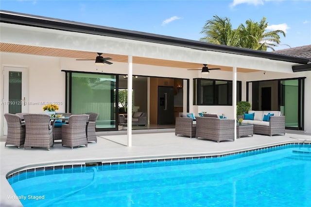 rear view of property featuring a ceiling fan, outdoor lounge area, a patio area, and an outdoor pool