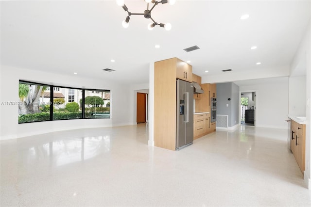 interior space featuring open floor plan, appliances with stainless steel finishes, an inviting chandelier, and visible vents