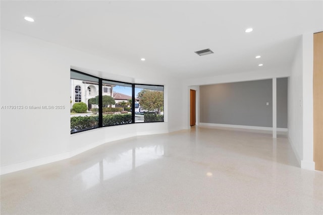 unfurnished room with recessed lighting, baseboards, speckled floor, and visible vents