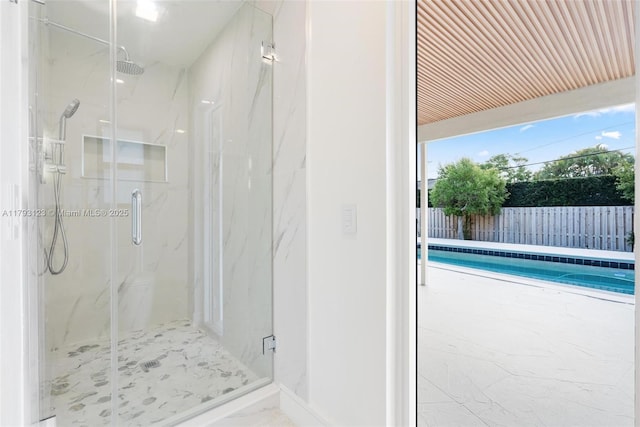 full bathroom with a marble finish shower