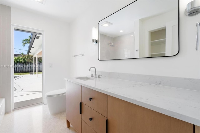 bathroom featuring vanity, walk in shower, and toilet