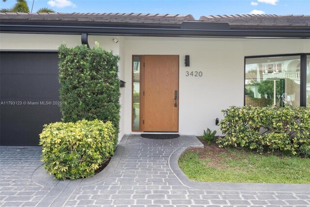 3420 NE 26th Ave, Lighthouse Point, FL 33064 - property entrance featuring stucco siding and a tiled roof