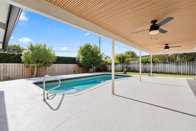view of swimming pool featuring a fenced in pool, a fenced backyard, a ceiling fan, and a patio area