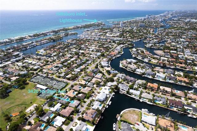 birds eye view of property with a residential view and a water view
