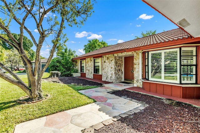 9866 NW 19th St, Coral Springs, FL 33071 - entrance to property with a yard, a tile roof, and stone siding