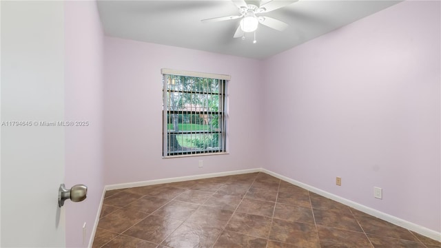 9866 NW 19th St, Coral Springs, FL 33071 - empty room with dark tile patterned flooring, baseboards, and a ceiling fan