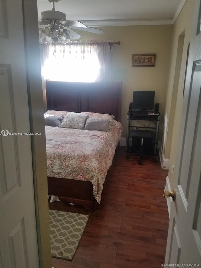 bedroom with crown molding, ceiling fan, and wood finished floors
