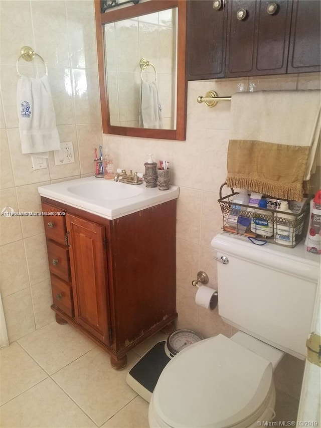 half bathroom featuring tile patterned flooring, vanity, toilet, tile walls, and decorative backsplash