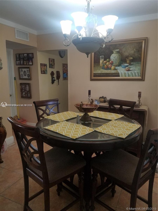 dining area with a notable chandelier, visible vents, ornamental molding, and light tile patterned floors