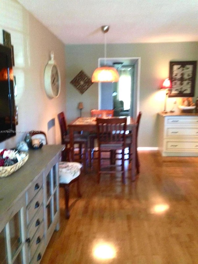dining room featuring baseboards and wood finished floors