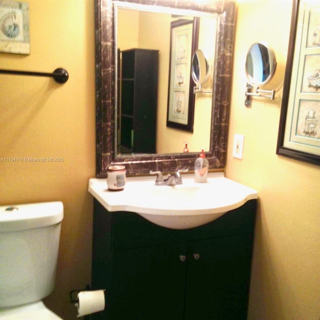 bathroom featuring vanity and toilet