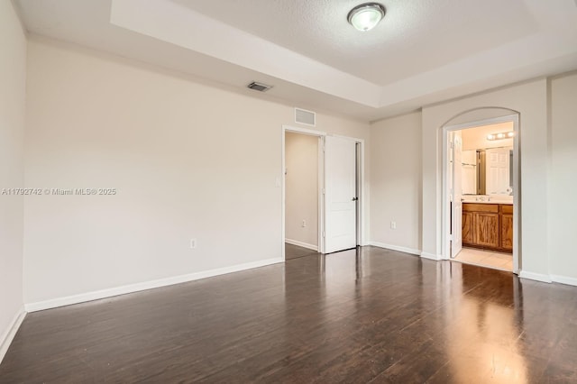 13945 SW 279th Ln, Homestead, FL 33032 - unfurnished bedroom featuring baseboards, visible vents, dark wood-style floors, and a raised ceiling