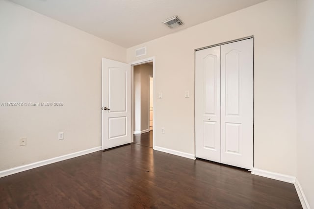 13945 SW 279th Ln, Homestead, FL 33032 - unfurnished bedroom featuring baseboards, dark wood finished floors, and visible vents