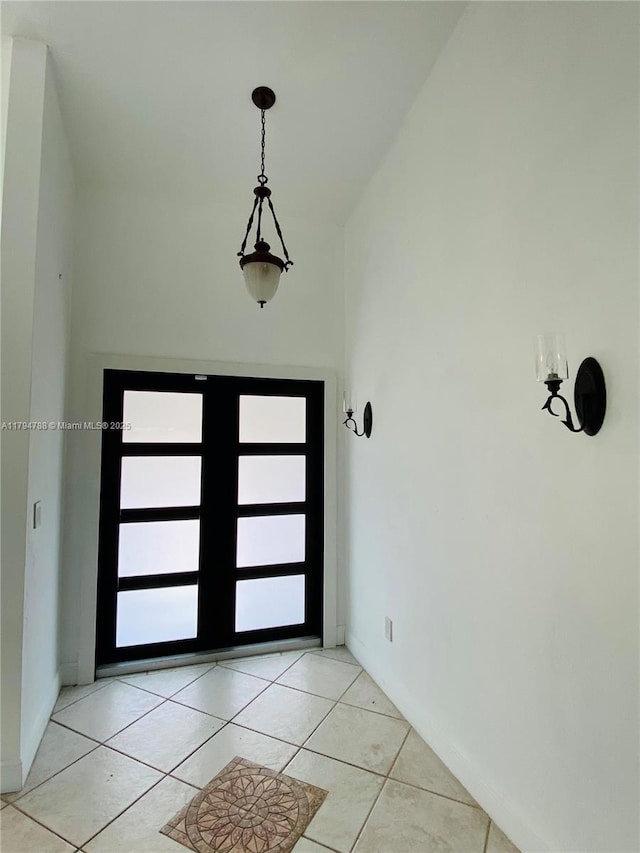entryway with light tile patterned flooring and baseboards