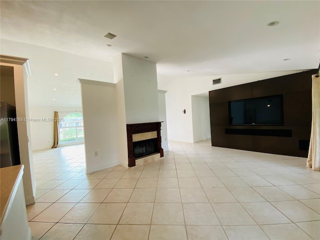 unfurnished living room featuring visible vents, lofted ceiling, a fireplace, recessed lighting, and light tile patterned floors