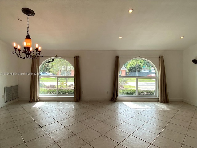 unfurnished room featuring light tile patterned floors, visible vents, a chandelier, and a healthy amount of sunlight