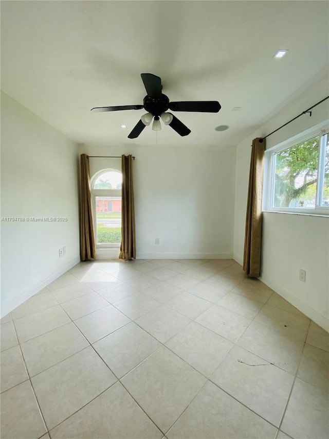 spare room with a ceiling fan, baseboards, recessed lighting, and light tile patterned floors