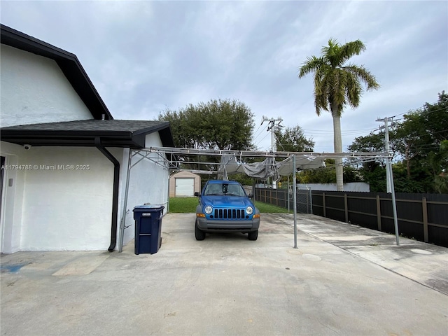 view of vehicle parking with fence