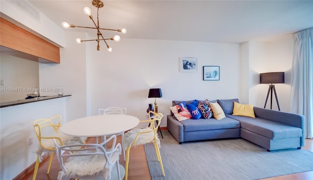 living area featuring a chandelier and wood finished floors