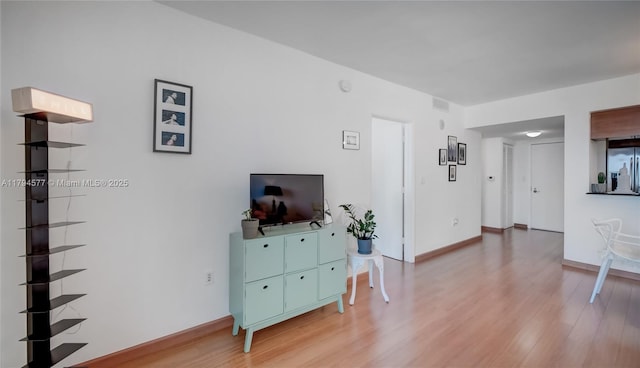 living room featuring baseboards and wood finished floors