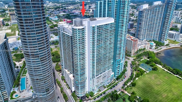 birds eye view of property with a water view and a city view