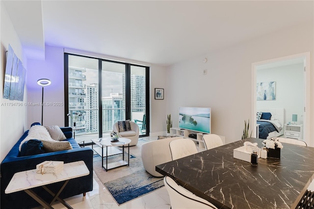 living area with floor to ceiling windows and marble finish floor