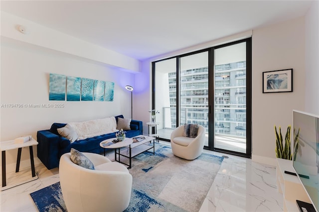 living room featuring marble finish floor, floor to ceiling windows, and a healthy amount of sunlight