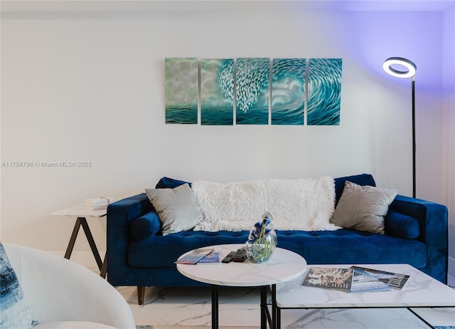 living area featuring marble finish floor