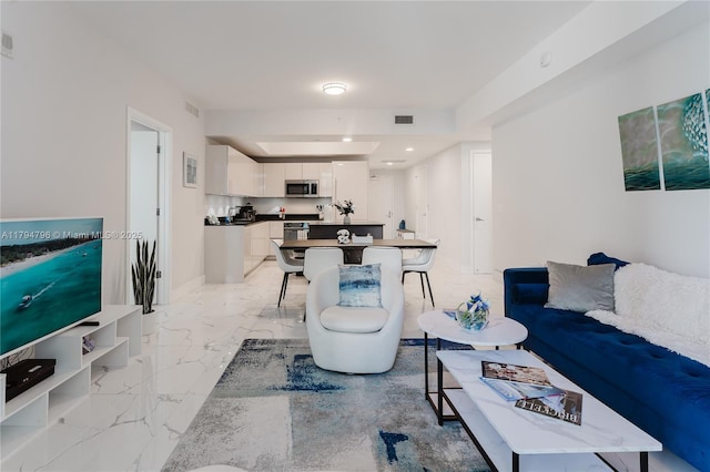 living area with marble finish floor and visible vents