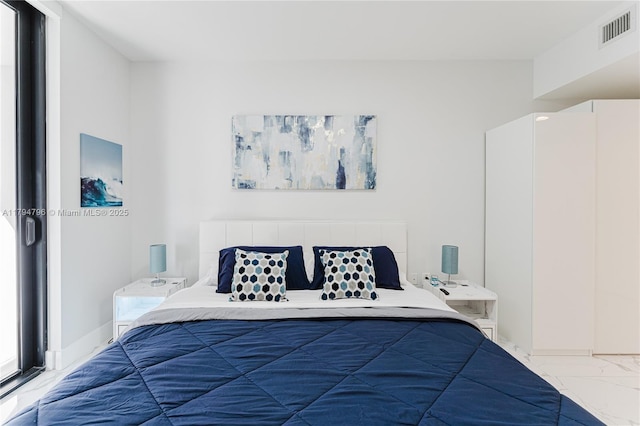 bedroom featuring visible vents and marble finish floor
