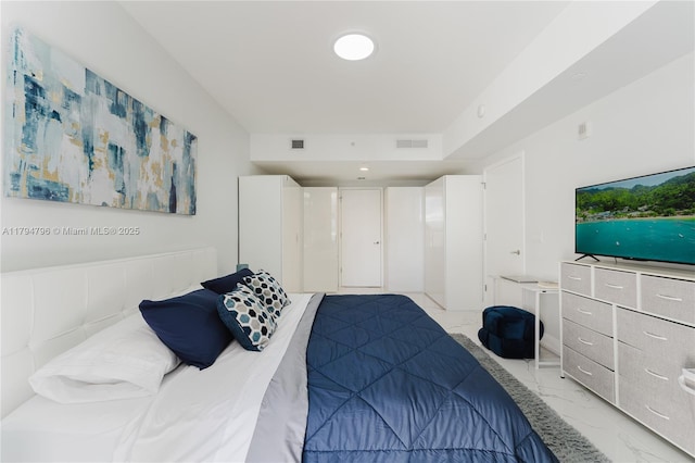 bedroom featuring visible vents and marble finish floor