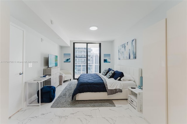 bedroom with floor to ceiling windows, access to outside, and marble finish floor