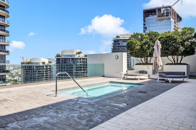 view of swimming pool with a community hot tub