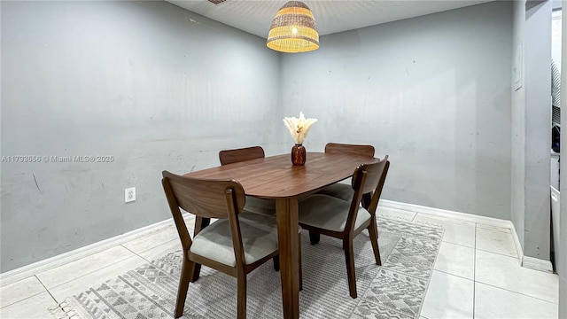dining space with light tile patterned floors and baseboards