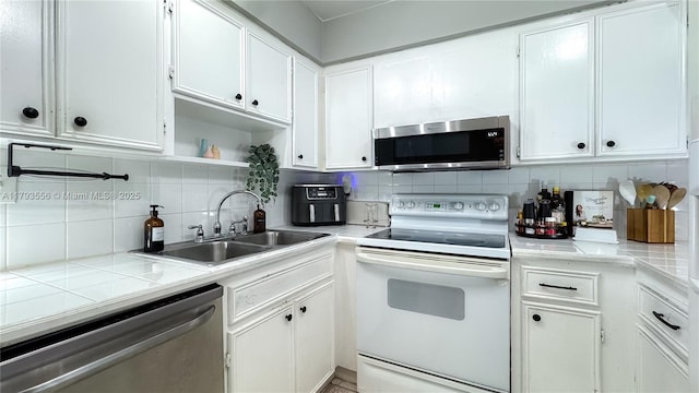 kitchen featuring white cabinetry, appliances with stainless steel finishes, and a sink