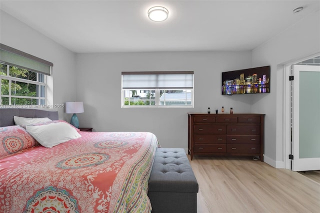 bedroom featuring multiple windows and light wood-type flooring