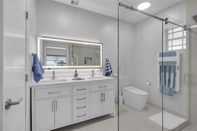 bathroom featuring toilet, visible vents, a shower stall, and a sink