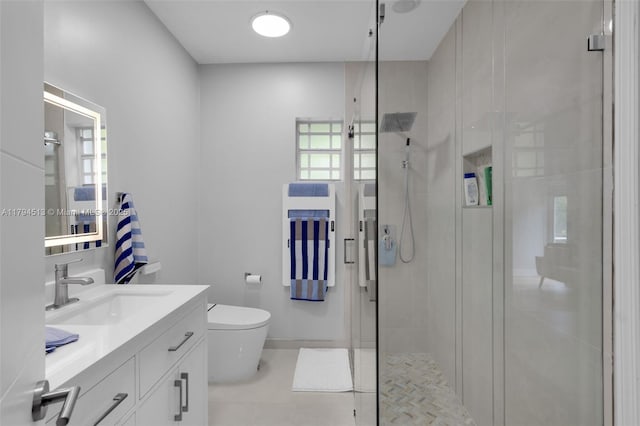 full bath featuring a stall shower, vanity, tile patterned floors, baseboards, and toilet