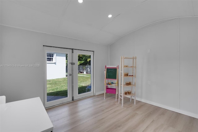 interior space featuring light wood-style floors, baseboards, recessed lighting, and lofted ceiling