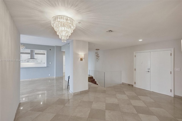 spare room featuring visible vents, baseboards, stairway, recessed lighting, and a chandelier