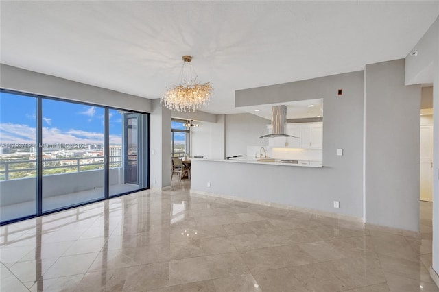 interior space featuring baseboards, marble finish floor, and a chandelier