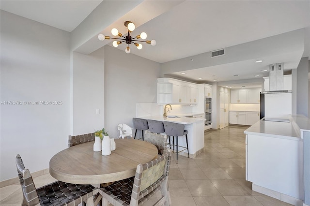 dining space featuring light tile patterned flooring, a notable chandelier, visible vents, and recessed lighting