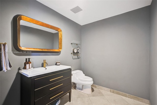 bathroom with visible vents, vanity, toilet, baseboards, and tile patterned floors